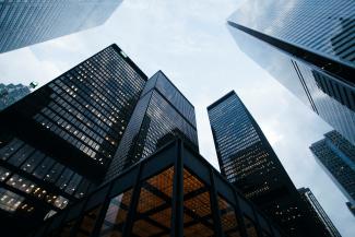 low angle photo of city high rise buildings during daytime by Sean Pollock courtesy of Unsplash.